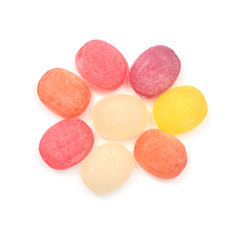 Multicolored sugar sweet sucking candy isolated on white background. Medical herbal lozenges. Sun shape. Flat lay, top view
