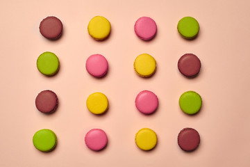 Colored macaron or macaroon, sweet meringue-based confection on pink background. Close-up, copy space.