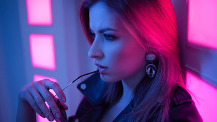 Futuristic style portrait in blue and purple light.