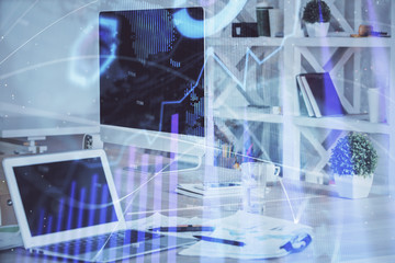 Fototapeta premium Stock market chart hologram drawn on personal computer background. Double exposure. Concept of investment.