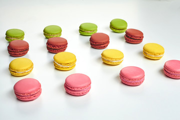 Colored macaron or macaroon, sweet meringue-based confection isolated on white. Close-up, copy space.