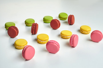 Colored macaron or macaroon, sweet meringue-based confection isolated on white. Close-up, copy space.