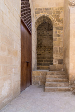 Stone staircase leading to vaulted entrance at stone bricks wall