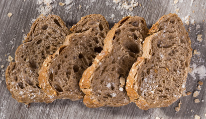 fresh slices of rye bread on wooden surface