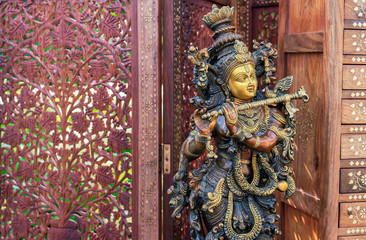 Hindu God Krishna. Statuette of Krishna playing the flute.