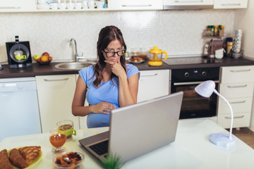 Pregnant woman with belly working as freelancer with laptop