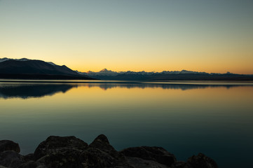 Spectacular panorama scenary of white Mount Cook and clear sky during sunset reflect in Pukaki Lake, South New Zealand.