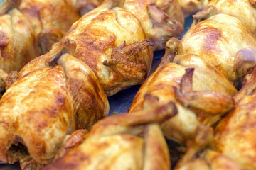 Cooked delicious grilled chicken in the market, selective focus.