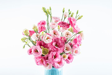 A beautiful bottle of eustoma flowers on a white background