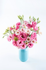 A beautiful bottle of eustoma flowers on a white background