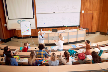Group of students listening to lecturer in the classroom.
