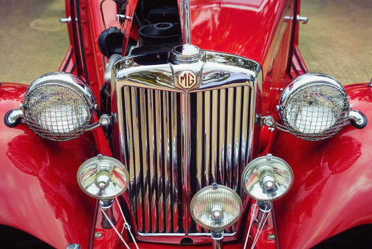 Front view, headlights and the grille of a red 1951 MG TD classic car on October 21, 2017 in Westlake, Texas.