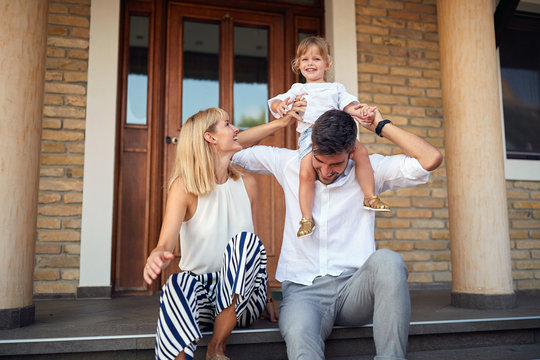 Child On Fathers Shoulders Sitting