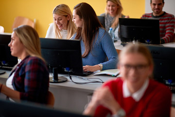 students having fun and smiling in lecture hall of modern college while enjoying classes.