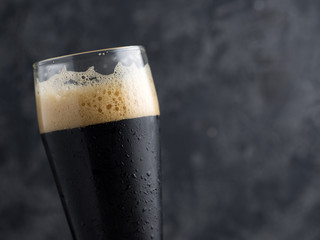 dark beer on a black background close-up. Beer porter