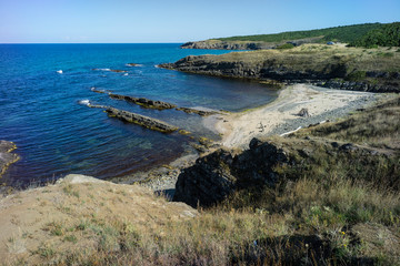 Coastline of Black Sea view from a high point showing bays of water with white sand amongst the rocky terrain edges.