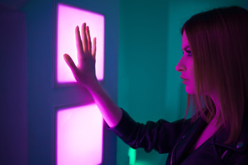 Futuristic style portrait in blue and purple light.