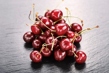 many sweet cherries on a black background