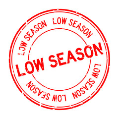Grunge red low season word round rubber seal stamp on white background