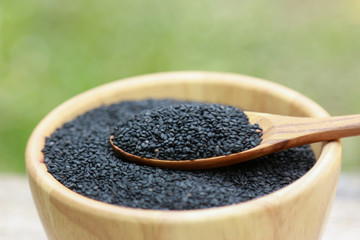 Black sesame on wooden bowl for healthy eating 