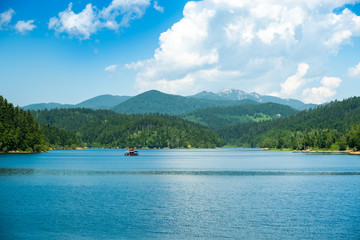 Fototapeta na wymiar Croatia, beautiful blue lake in Gorski kotar, Lokve, Croatia, with Risnjak mountain in background, reflection in watter