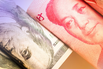 Face to face of Benjamin Franklin and Mao Tse tung from US dollar and China Yuan banknote. It is symbol of economic tariffs trade war.