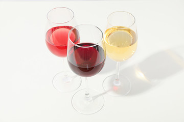 Glasses with different wine on white background, copy space