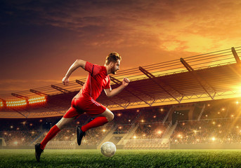 Soccer player in action on a stadium. Dribble the ball. Soccer game. Sports championship. Soccer field.