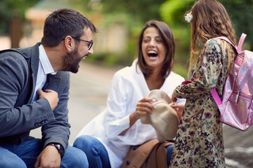 Fototapeta premium parents with there daughter after school