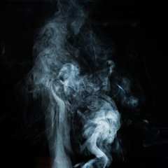 Abstract white smoke effect isolated on black background.