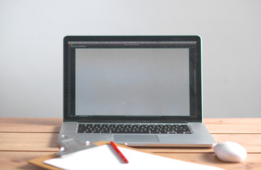 Laptop stands on a wooden table in office