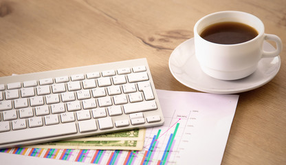 Office table with blank notepad and laptop