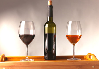 wine bottle and wine glass on a glass table