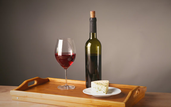 Wine Bottle And Wine Glass On A Glass Table