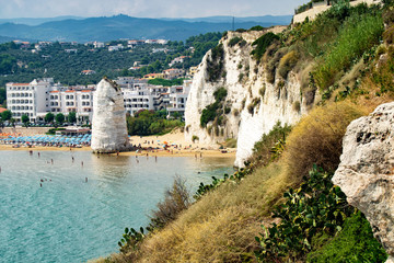 Vieste, Gargano, Apulia, Pizzomunno monolith on the seashore with parasols