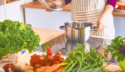 Young Woman Cooking in the kitchen. Healthy Food