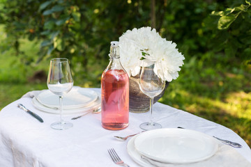 Serving plates with table ware on white cloth outdoor