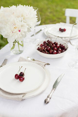 Serving plate with sweet cherry and tableware