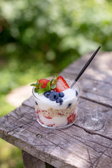 Close up granola with strawberries on wooden board