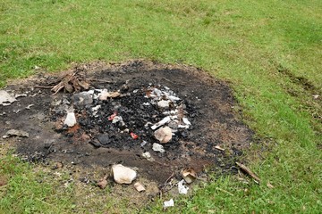 Coals burned in the forest where a barbecue was made. Close up.