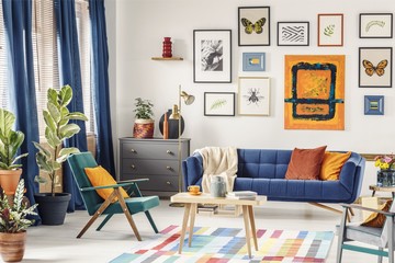 Simple posters hanging on the wall in bright living room interio