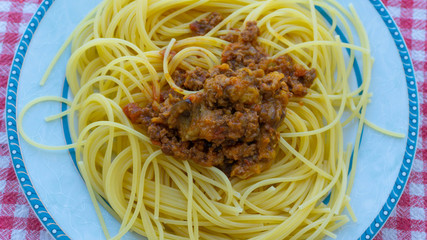 Spaghetti bolognose pasta plate on red table cloth