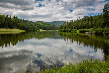 Obraz na płótnie Canvas Hurricane Lake reflects the sky in the back country of the White Mountains of east central Arizona.