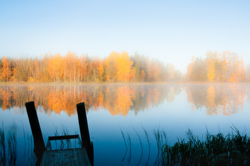 Beautiful autumn morning landscape of Kymijoki river waters and pier in fog. Finland, Kymenlaakso,...