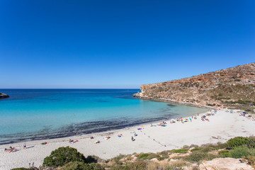 Fototapeta na wymiar Lampedusa Island Sicily - Rabbit Beach with no people and Rabbit Island Lampedusa “Spiaggia dei Conigli” with turquoise water white sand at paradise beach.