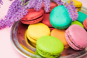tasty colorful macarons on pink background