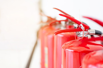 Red fire extinguisher close up focus  - obrazy, fototapety, plakaty