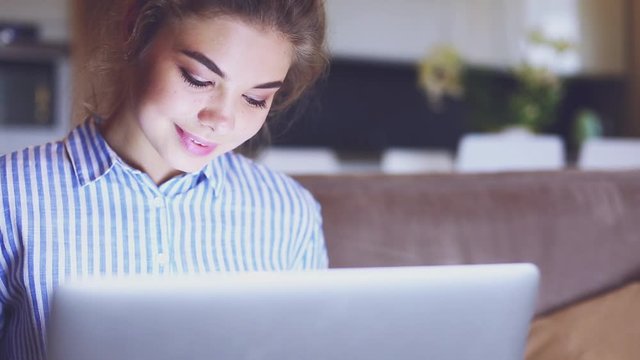Girll is making online payment. Girl holding bank card using modern laptop
