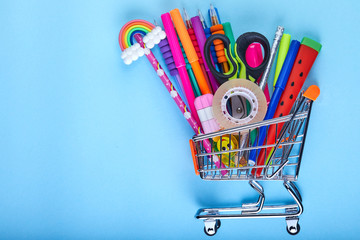 Banner of Shopping cart with school supply on a blue background with copy space. Back to school concept
