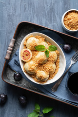 Freshly boiled plum dumplings topped with sweet toasted breadcrumbs